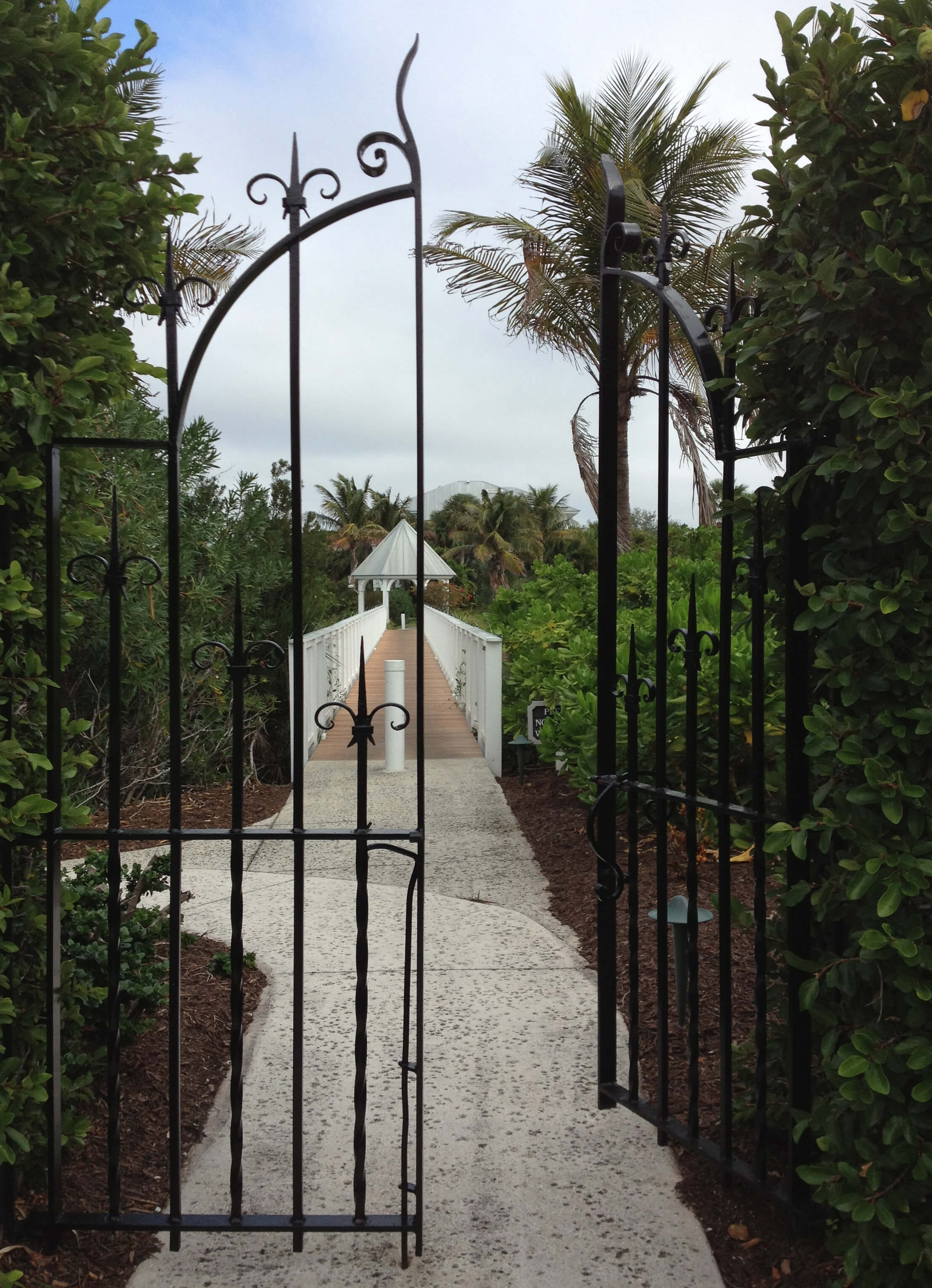 An open gate on an island of many gated communities