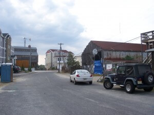 The tumble down warehouse on the right and the simulacra at the end of the street.