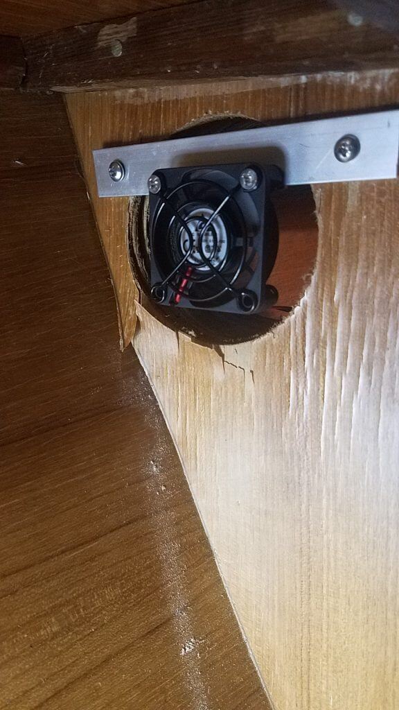 fan installed in locker with peeling veneer