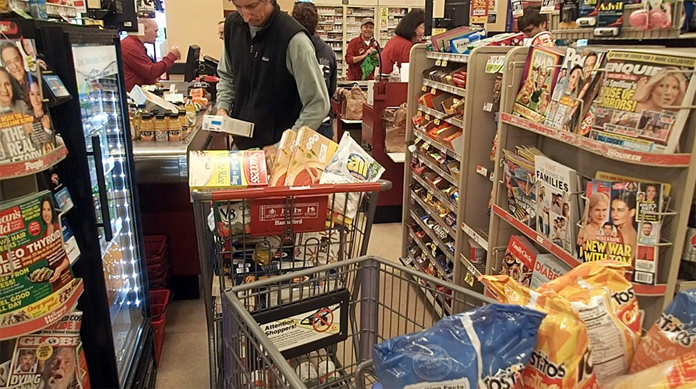 man with a shopping cart full of groceries